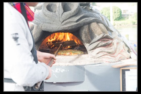 Pizza cooking in a wood fired oven