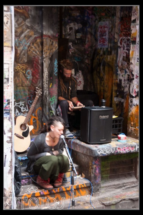 These two buskers were at the end of the a very dark alley on a rainy day