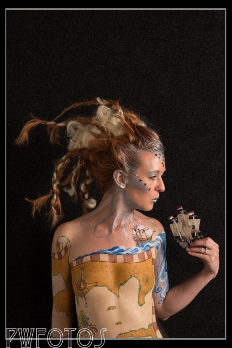 This shot against the black panel provide good separation of model to background. The lighting is more dramatic because it uses a single light camera right and a silver reflector on the left.